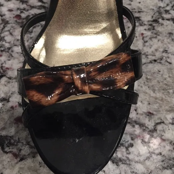 Black strappy platform shoes w animal print bow.