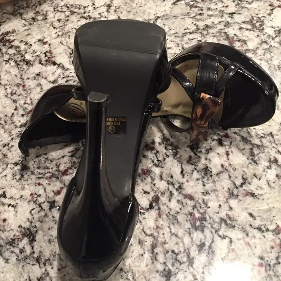 Black strappy platform shoes w animal print bow.