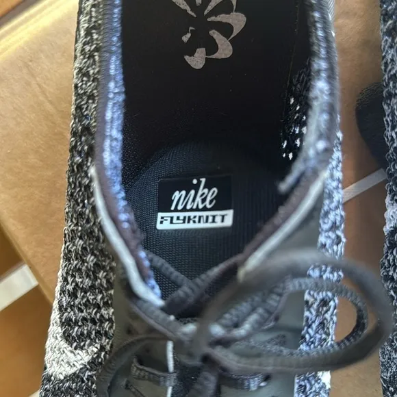 Nike air Flyknit black and white athletic shoes
