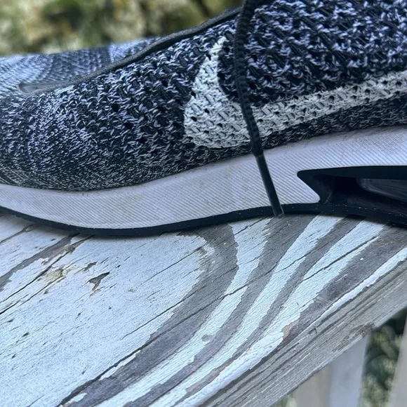 Nike air Flyknit black and white athletic shoes